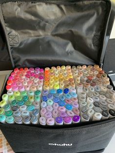 an open case filled with lots of different colored crayons in it's lid