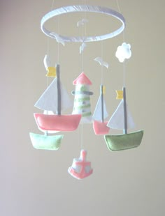 a baby mobile with sailboats and ships hanging from it