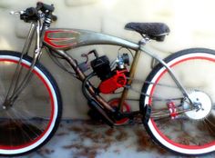 a bike with red and white rims parked against a wall