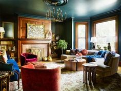 a living room filled with lots of furniture and a chandelier hanging from the ceiling