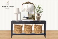 a console table with three baskets on it and a mirror in the corner behind it