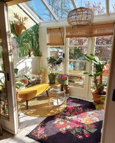 a sun room with lots of plants in it