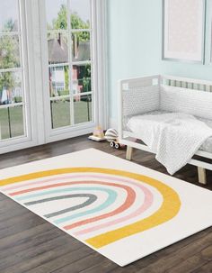 a child's room with blue walls and wooden flooring, a white rug on the floor