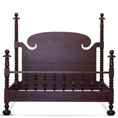 a wooden bed frame with four posts and an intricate headboard, made in solid wood