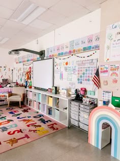 a classroom with lots of desks, chairs and pictures on the wall above them