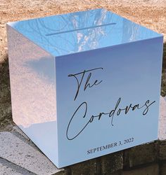 a blue box with the word the cordovas written on it sitting in front of a brick wall