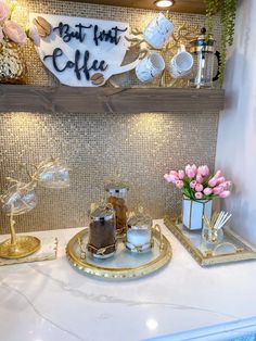 the counter is decorated with gold and white dishes