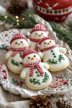 christmas cookies decorated like snowmen on a plate