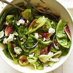 a white bowl filled with salad on top of a table