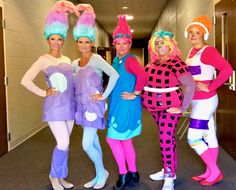 four women dressed in costumes posing for the camera