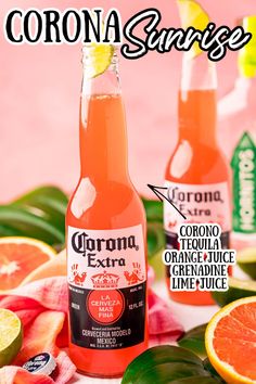 two bottles of corona extra orange juice next to sliced grapefruit and tropical leaves