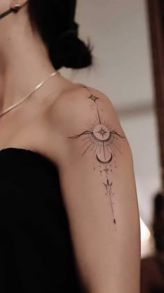 a woman's arm with a tattoo on it that has a sun and stars