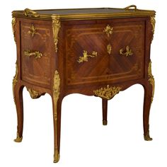 an ornately decorated wooden cabinet with gold accents