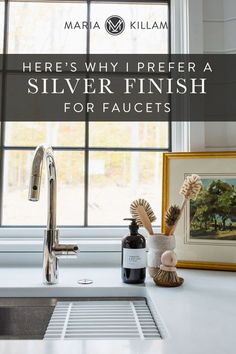 a kitchen sink under a window with the words here's why i prefer a silver finish for faucets