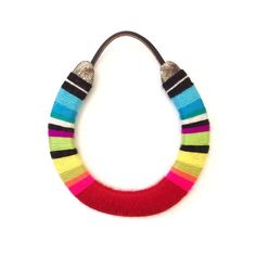 a multicolored necklace on a white background