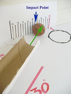 a basketball sitting on top of a cardboard box next to a ruler and paper bag