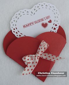 valentine's day card with heart cut out and ribbon tied around the edge, on white background