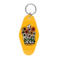 a yellow plastic keychain with flowers on the front and back sides, hanging from a metal ring