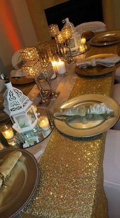 the table is set with gold sequins and candles