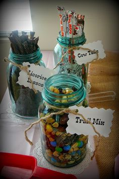 three jars filled with candy sitting on top of a table