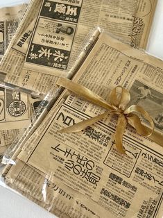 newspapers wrapped in brown paper with a bow