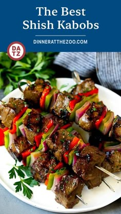 skewered meat and vegetables on a white plate