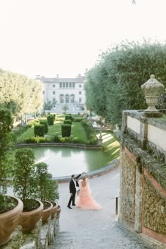 a bride and groom are walking down the stairs to their wedding ceremony at villa d'oro