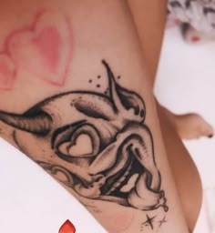 a woman's leg with a tattoo on it and a heart in the background