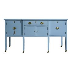 a blue sideboard with two drawers and brass pulls on the bottom, against a white background