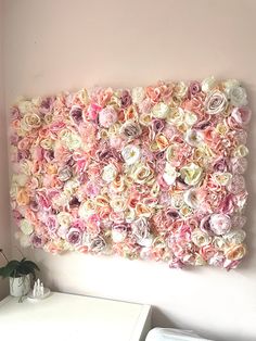 a large flowered wall hanging over a white dresser