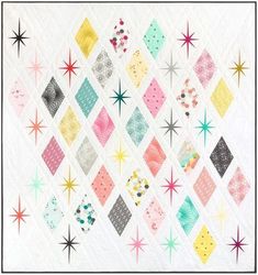 a quilt with many different colored squares and stars on the front, along with an image of