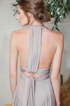 the back of a woman wearing a gray dress