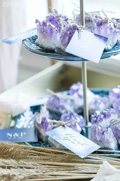 purple crystals are displayed on a tray in front of other items for sale at a store