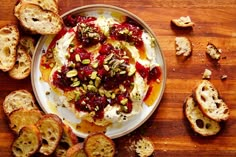 a plate with bread and cranberry sauce on it next to some crackers