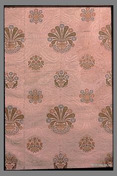 an old pink and gold wallpaper with ornate designs on it's edges,