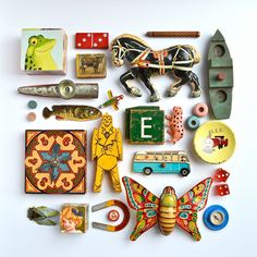 an assortment of assorted items are displayed on a white surface, including toys and magnets