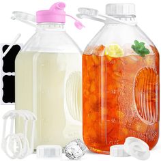 two large jugs filled with liquid next to each other and ice cubes on the side