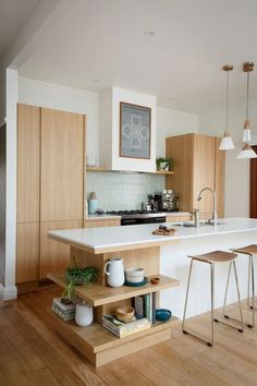 a kitchen with wooden floors and white counter tops