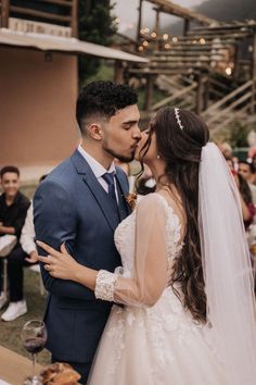 a bride and groom kissing in front of an audience