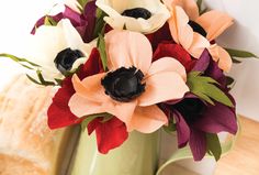 an arrangement of flowers in a vase on a table