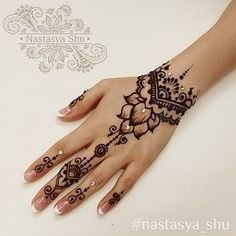 a woman's hand with henna tattoos on it