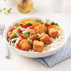 a white bowl filled with food next to a fork