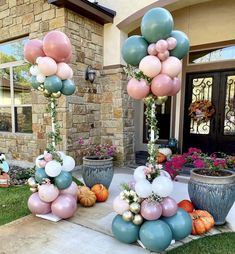 some balloons and flowers in front of a house