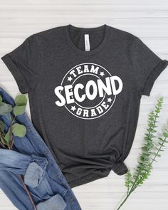 This is a Second Grade Teacher Shirt that says Team Second Grade. It is the perfect shirt for a group of Second Grade Teachers or a gift for your favorite 2nd Grade Teacher.  This shirt would be great for back to school.  Choice of shirt color as pictured, all are a super soft Bella Canvas brand heathered material.  T-shirts are 52% cotton, 48 % polyester, except heather black is 90% cotton, 10% polyester. Refer to size chart in listing for sizing details. Shirts run true to size for a unisex fit.  Size down if you prefer a more fitted shirt.  This design is made with high quality heat transfer vinyl, pressed with a commercial grade heat press.  Care Instructions: Machine wash cold inside out, air dry, do not iron design or dry clean shirt. Please contact me with any questions. If you need Class Shirt, Teacher Team, 2nd Grade Teacher, Second Grade Teacher, Teacher Tshirts, Second Grade, 2nd Grade, Heather Black, Perfect Shirt