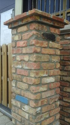 a fire hydrant sitting on the side of a brick building