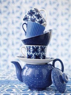 a stack of blue and white teapots sitting on top of each other