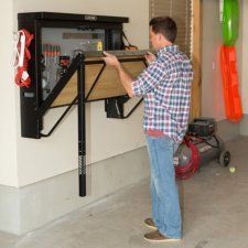 a man standing in front of a wall mounted device