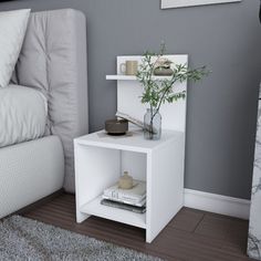 a small white shelf next to a bed with a plant on top and books in it