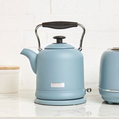 a blue tea kettle sitting on top of a counter