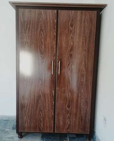 a wooden cabinet with two doors in a room